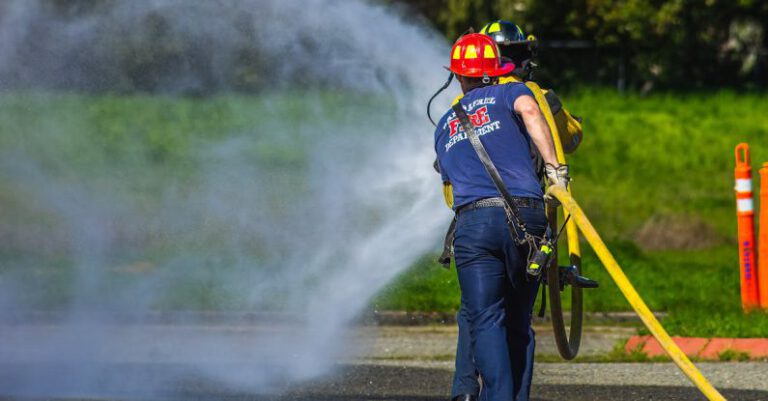 Safety Tips - A firefighter spraying water on a road