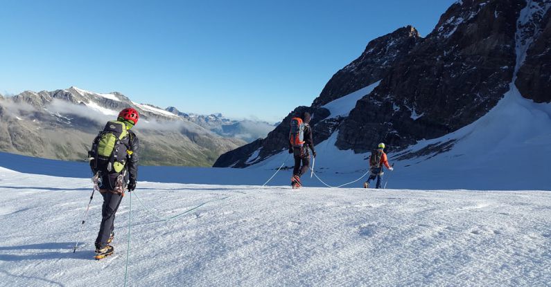 Expedition - Man Walking on Snow Covered Mountain