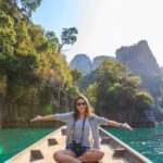 Trip - Photo of Woman Sitting on Boat Spreading Her Arms