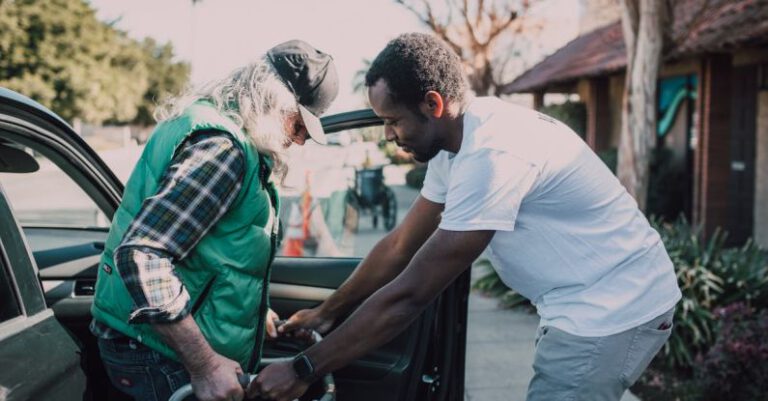 NGOs - Man Assisting Person with Walker