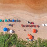 Tide Pools - Sandy ocean coast with colorful umbrellas