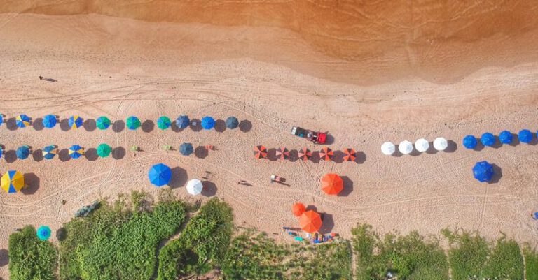 Tide Pools - Sandy ocean coast with colorful umbrellas