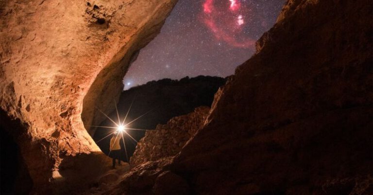 Discoveries - Person Walking with Flashlight among Rocks at Night