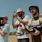 Technologies - A Low Angle Shot of Bearded Men Shooting a Film while Wearing Bucket Hats